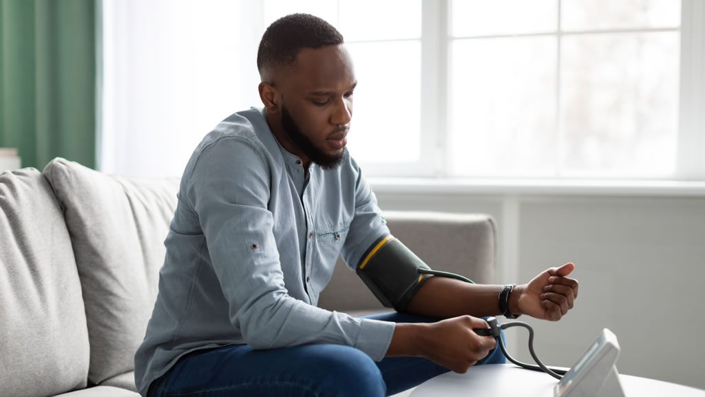 man taking blood pressure at home